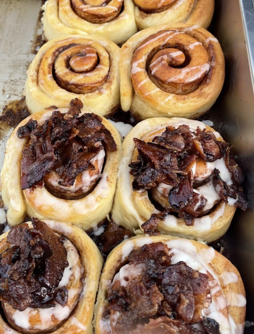 Freshly baked cinnamon rolls topped with chocolate and nuts.
